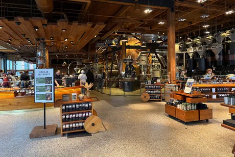 The Seattle Roastery interior, with roasting machinery behind the bakery and coffee counters beneath a timber ceiling.